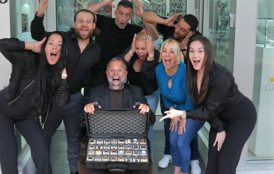 CRM Jewelers team celebrating with a case of luxury watches — £9.3M generated on Raffall